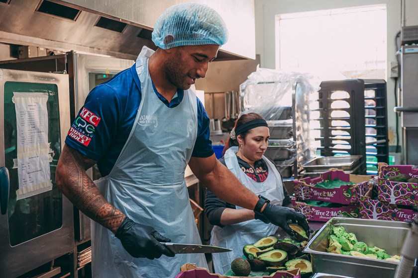 Viliame Kikau tackles the food prep as the Bulldogs visit the Rev Bill Crews Foundation on Monday to give back to the local community and help those less fortunate.