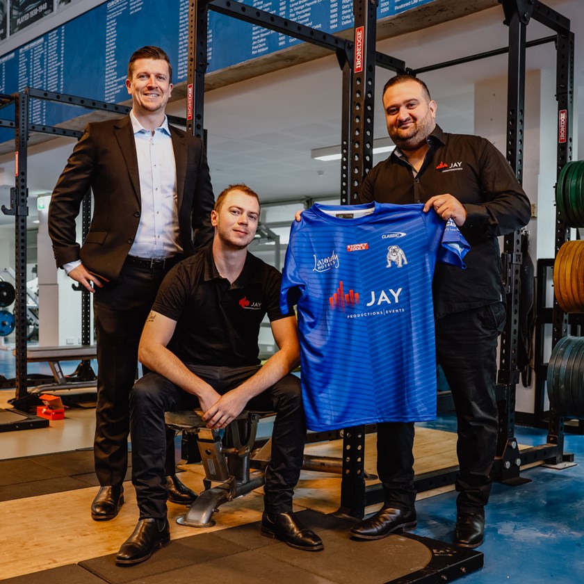 Jay Productions & Events Director, Jason Ghazal and General Manager, Phillip Dearle with Bulldogs CEO, Aaron Warburton, holding the 2023 training shirt.