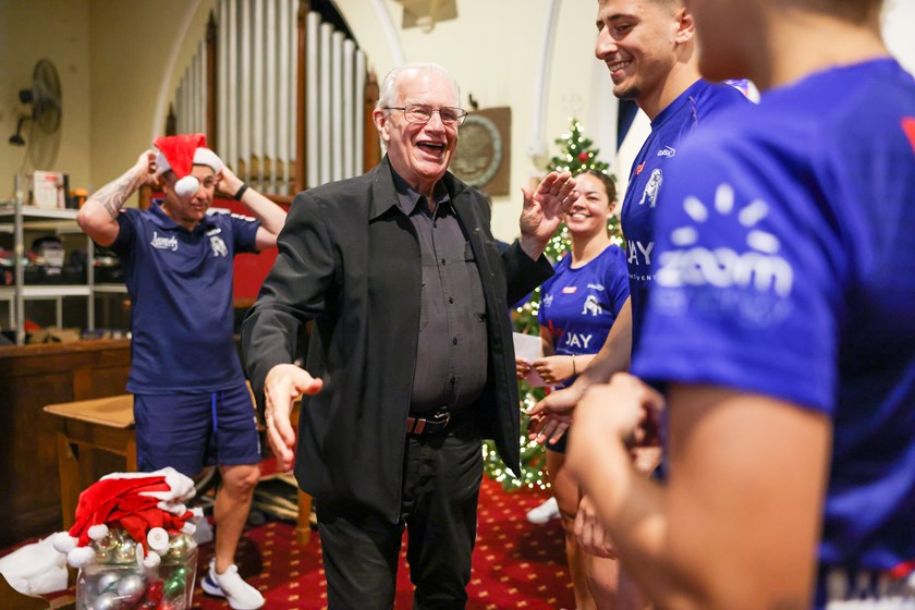 Rev. Bill Crews shares the Christmas cheer with Members of the Bulldogs Harvey Norman Womens and NRL sides.