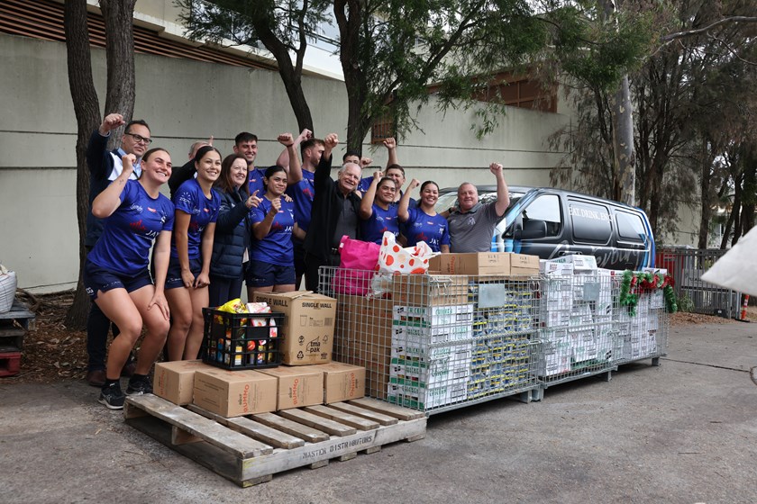 Bulldogs Chairman John Khoury, Canterbury League Club President Peter Winchester, Rev. Bill Crews, Terry Lamb, Luke Goodwin and Bulldogs NRL and Harvey Norman Women's players unite  to donate over $5k worth of food to the Xmas appeal