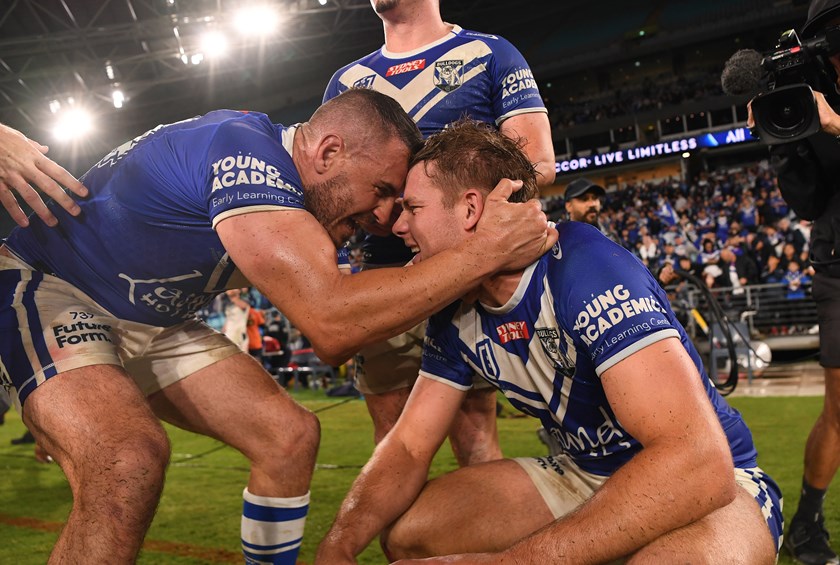 Josh Reynolds embraces Matt Burton following a golden point victory over the Cowboys in Round 5 on the NRL premiership.