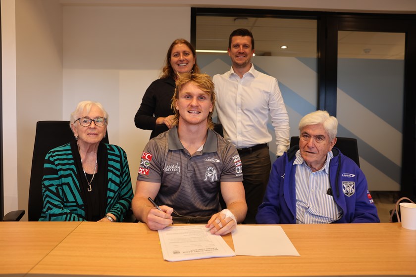 Jacob Preston is joined by members of his family and Bulldogs CEO Aaron Warburton as he signs a three-year extension with the Club.