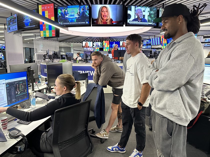 Sports journalist Emma Lawrence talks the players through a story she is working on, at the Nine Network's inner sanctum.