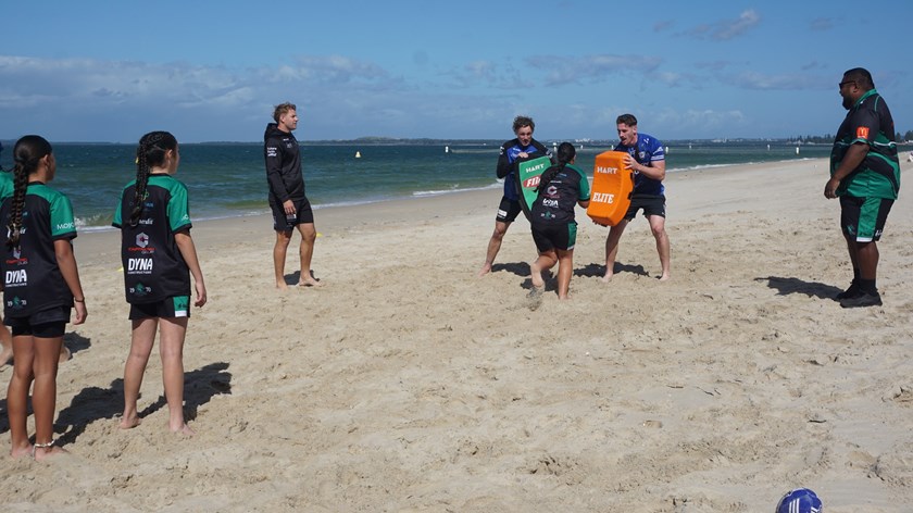 Bulldogs players Matt Burton, Kurt Mann and Harry Hayes (L to R)  help members of the Milperra Colts train at Brighton Beach.