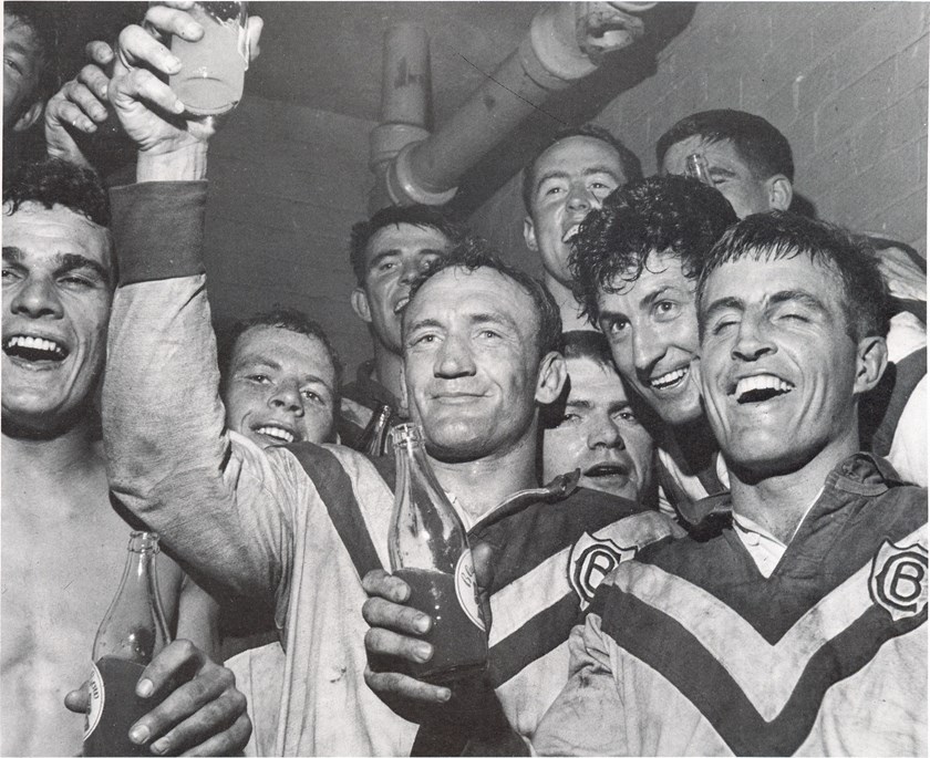 Winners Are Grinners: Captain/Coach Kevin Ryan (centre) raises a glass with his teammates after knocking off 11-time Premiers, St George. 